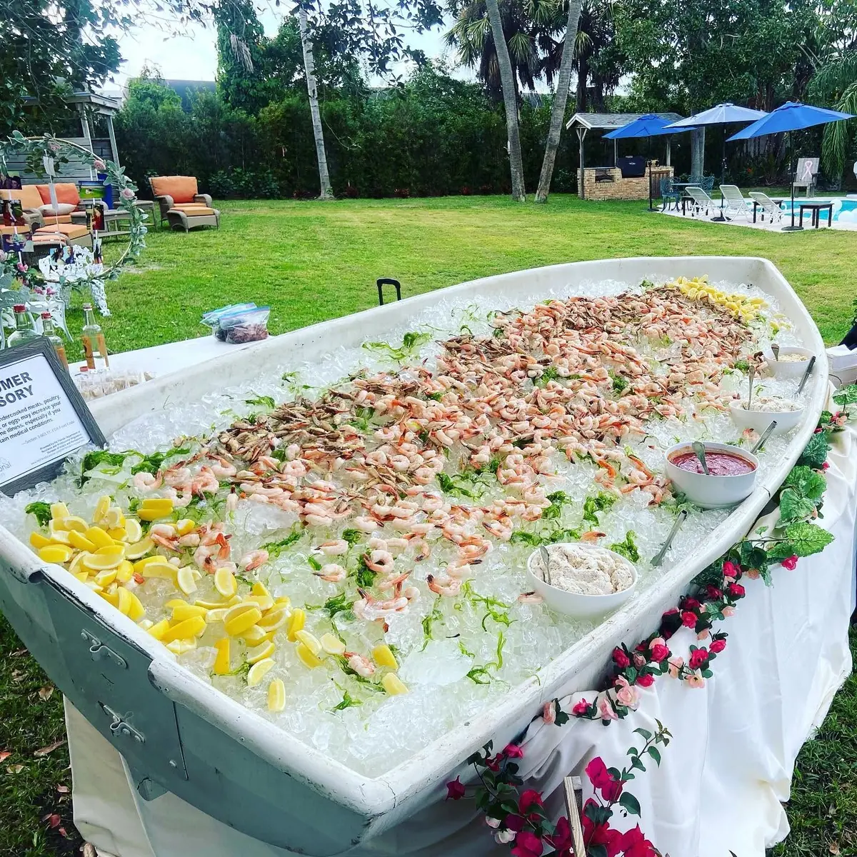 Huck's signature Seafood Boat — a raised ice tray loaded with a full seafood spread at an outdoor event